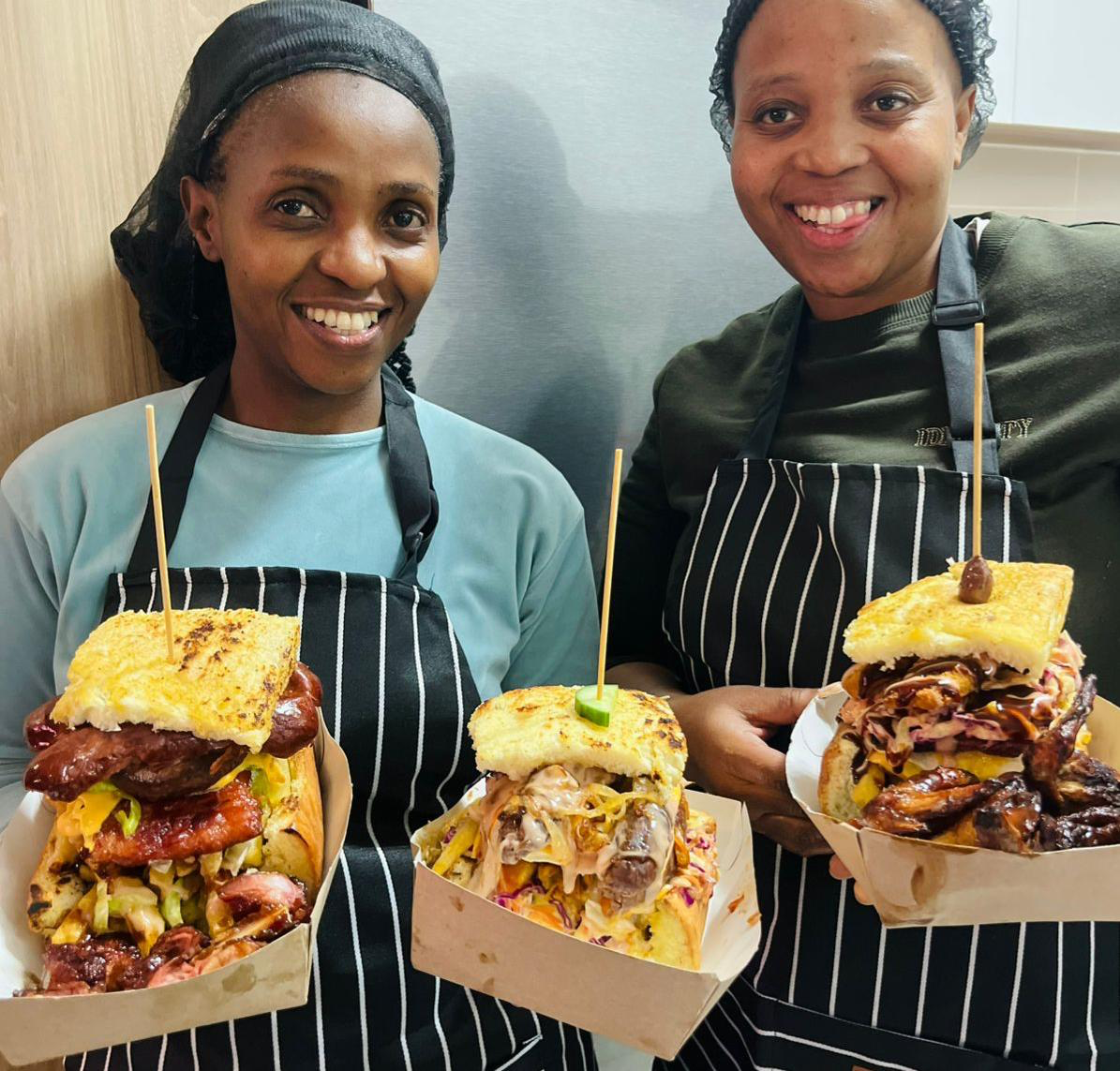Mipru's Kitchen team smiling and serving food